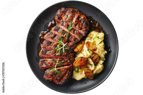 Grilled Sliced Beef Steak with Roasted Potatoes and Mashed Potato on a Dark Plate