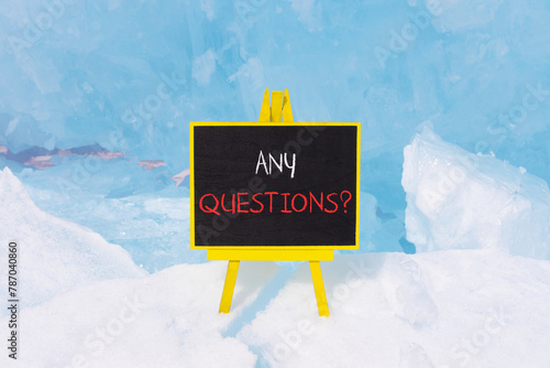 Any questions symbol. Concept words Any questions on beautiful yellow blackboard. Beautiful forest snow blue sky background. Business and Any questions Q and A concept, copy space. photo