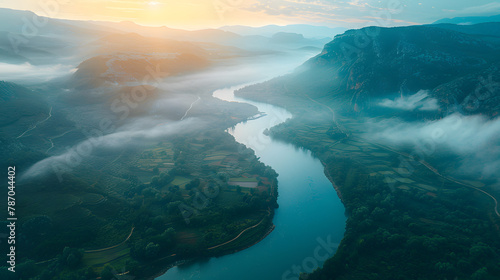 River meandering through mountain valley  under a serene sky