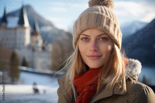 Portrait of a content woman in her 30s dressed in a warm ski hat in backdrop of a grand castle