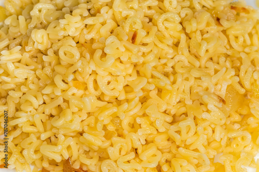 Heap of boiled alphabet pasta, top view in selective focus Heap of boiled alphabet pasta, top view in selective focus