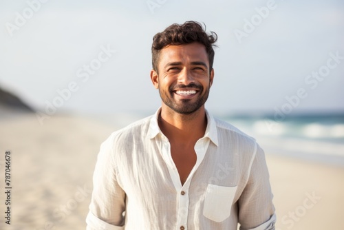 Portrait of a happy indian man in his 30s wearing a classic turtleneck sweater over pristine snowy mountain