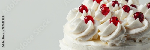 Cake with perfect whipped cream swirls and some small details of red berries on top  very luxurious  with light gray background. Banner