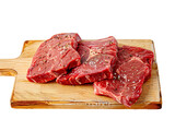 photo of red meat beef on light wooden advertising board in front view angle white background isolated PNG
