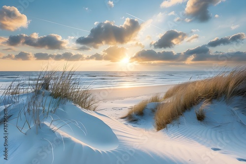 The sea  white sand  and green grass are all beautiful. As dusk falls on the sandy shore  waves break over the lake. Beautiful natural scenery with a path on the beach that leads to the ocean during s