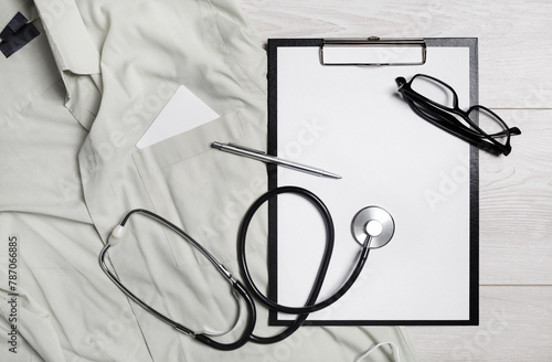 Health care template. Blank medical clipboard, stethoscope, glasses and pen. Flat lay.