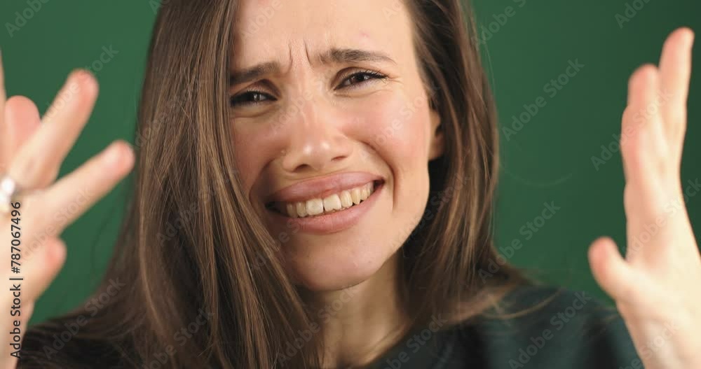 Frustrated nervous woman mad touch head against green background. Annoyed irritated young woman with an angry face looking furious, mad and feeling frustrated, yelling she look shocked, facepalm, wtf. Frustrated nervous woman mad touch head against green background. Annoyed irritated young woman with an angry face looking furious, mad and feeling frustrated, yelling she look shocked, facepalm, wtf.