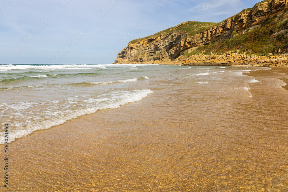 Luaña beach with golden sand and Cantabrian Sea waves. Cantabria, Spain.