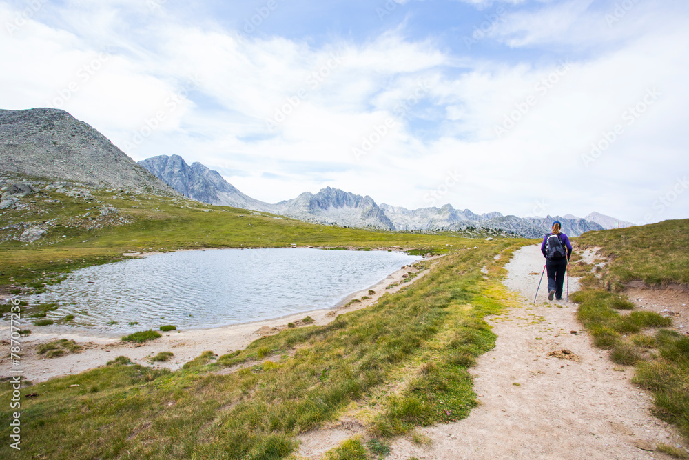 Young hiker woman in Vall de Boi, Aiguestortes and Sant Maurici National Park, Spain