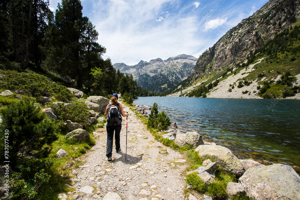 Young hiker woman in Vall de Boi, Aiguestortes and Sant Maurici National Park, Spain Young hiker woman in Vall de Boi, Aiguestortes and Sant Maurici National Park, Spain