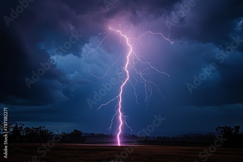 An intense purple lightning bolt forks across the night sky, illuminating the dark agricultural field below