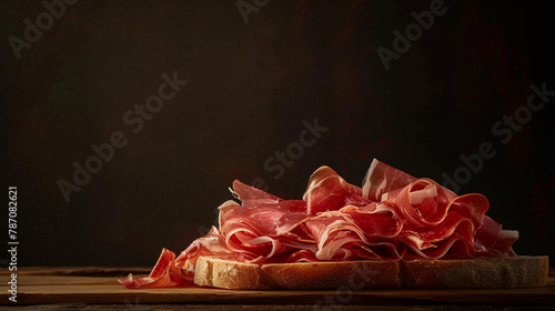 a bread with ham on it sits on a table photo