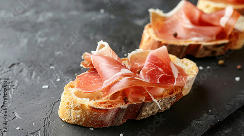  bread with ham on it sits on a table photo