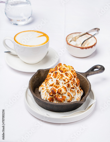 meringue cake with coffee on table