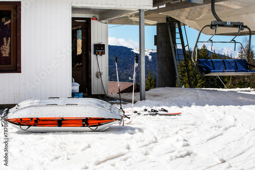rescue sled for injured skiers near the ski slope on a sunny day. Active and relaxing holiday © Nataliia Makarovska