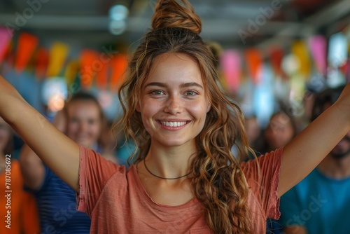 Joyful young woman with arms wide open, enjoying a vibrant party atmosphere with colorful decorations