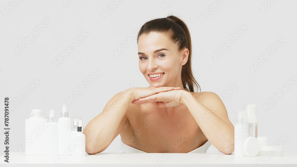 Happy mature middle-aged woman touching face and looking at camera. Healthy, dry skin care concept, cosmetics and anti-aging plastic surgery. Happy mature middle-aged woman touching face and looking at camera. Healthy, dry skin care concept, cosmetics and anti-aging plastic surgery.