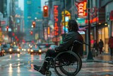 Disabled man in wheelchair sitting on the side of the wet road during a rainy day