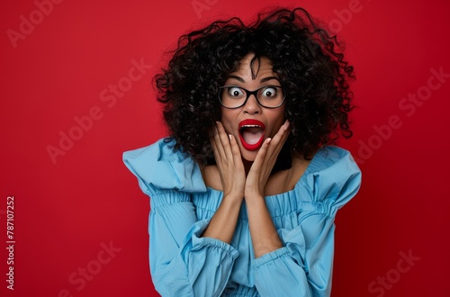 Woman in Blue Shirt and Glasses Making a Surprised Face photo