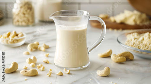 A pitcher of milk with cashews and nuts. photo