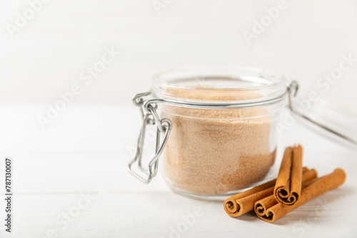 Cinnamon sugar on a texture background. Homemade cinnamon sugar in a bowl on background. Brown sugar. Spice mixture for drinks and baking. Place for text. Copy space.