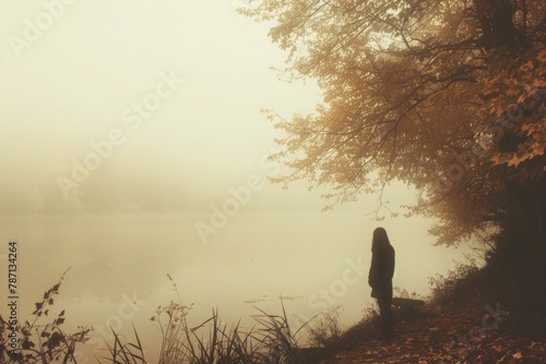 A solitary woman shrouded in autumnal mist merges with the foggy backdrop her introspective expression epitomizing melancholic solitude