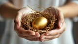 The concept of saving and increasing savings is symbolized by female hands holding a nest with a golden egg.