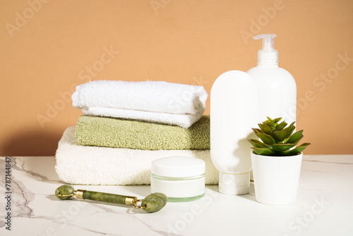 Spa products in the bathroom. Shampoo, cream, towels. Natural cosmetic background. © nadianb