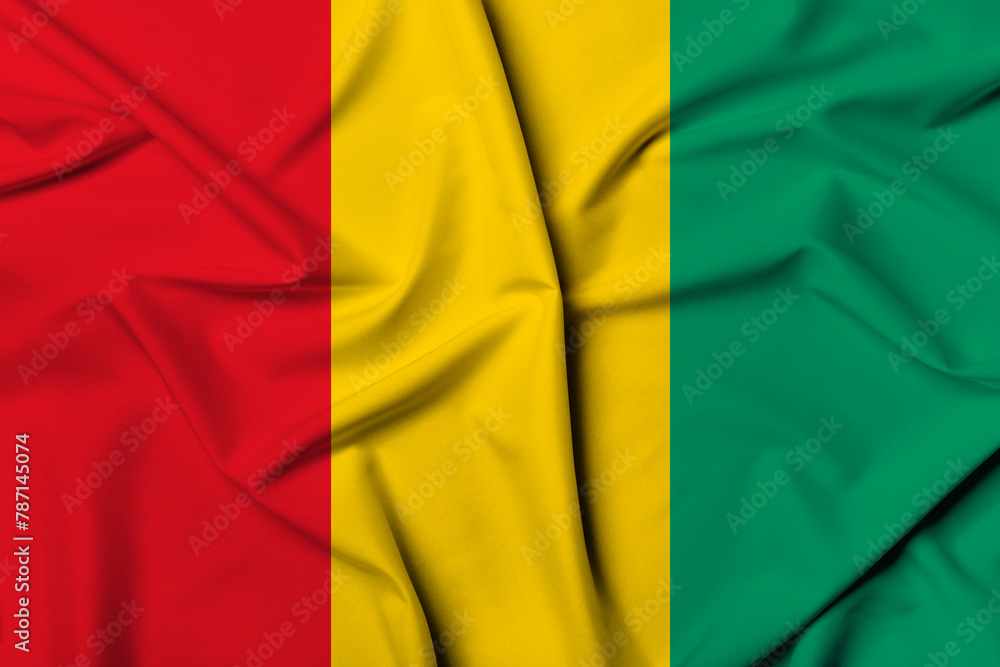 Fototapeta premium Beautifully waving and striped Guinea flag, flag background texture with vibrant colors and fabric background