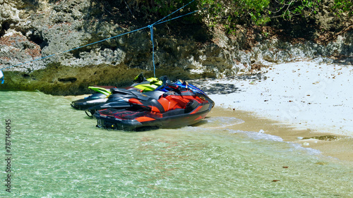 Two Jet Skis in the water near the beach. Two Jet Skis are parked in the sea near the beach on the shore of a tropical island.