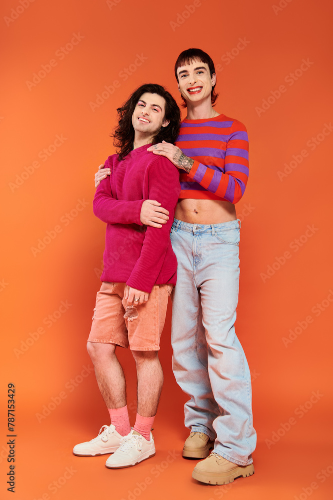 appealing stylish jolly gay friends in vibrant clothes posing happily together, pride month appealing stylish jolly gay friends in vibrant clothes posing happily together, pride month
