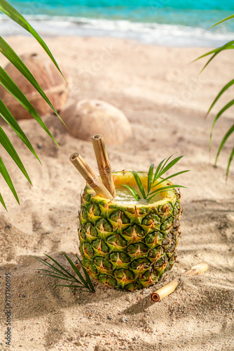 Fresh and tasty cocktail in pineapple on a tropical island.