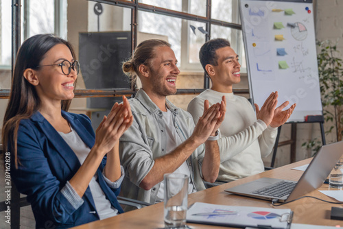 Φωτογραφία Happy group of businesspeople clapping in office