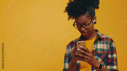 Merry young black lady in casual outfit using modern smartphone and looking at copy space reading exciting advertisement yellow studio background panorama Mobile application concept : Generative AI photo