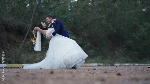 Romantic beautiful wedding couple laugh and kiss on honneymoon, slow motion photo