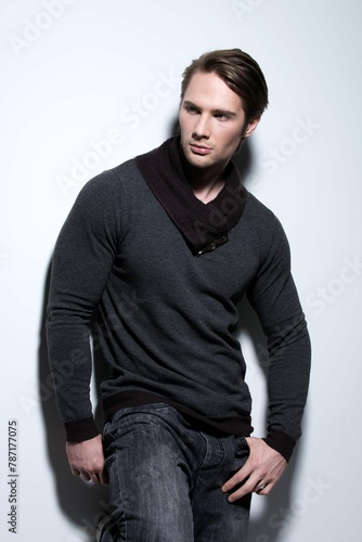 Fashion Portrait Sexy Handsome Man Gray Pullover Poses Wall With Contrast Shadows Looking Sideways © Sharayah
