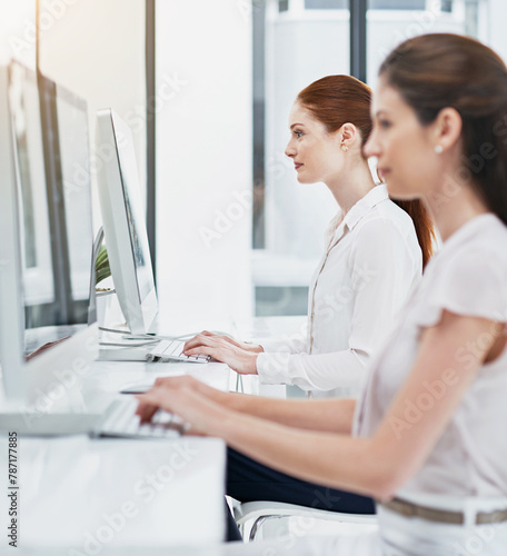 Business woman, team and typing with computer for design agency, website or productivity at office. Female person, journalist or employees working on technology in row or line for email at workplace