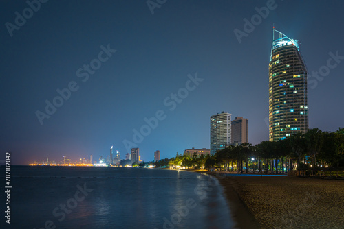 Night view of a beautiful beach in Pattaya, Thailand with highrises and city lights in background photo