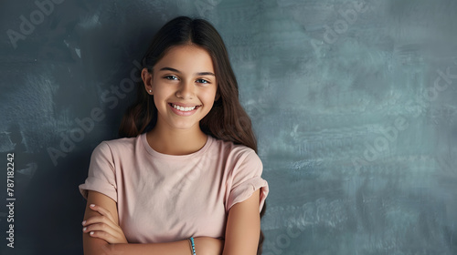 Portrait of a young latin woman with pleasant smile and crossed arms isolated on grey wall with copy space Beautiful girl with folded arms looking at camera against grey wall Cheerful : Generative AI