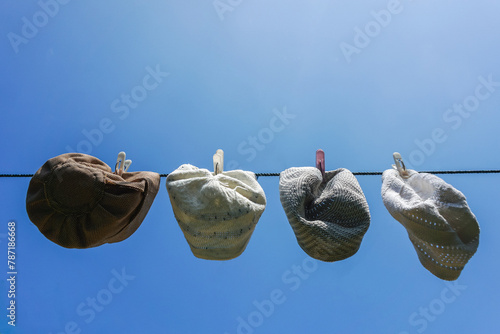 Muslim skull cap dry after washed on sunny day. Washing dirty kopiah. Peci or mulim hat photo