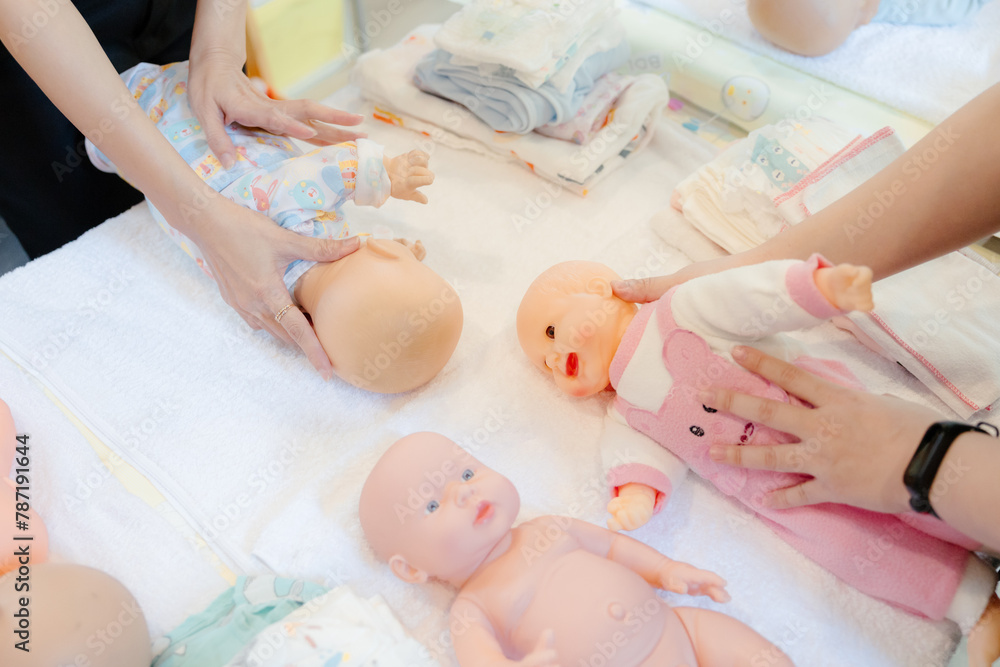 New mothers receive training from experts on swaddling their newborns through classes. New mothers receive training from experts on swaddling their newborns through classes.