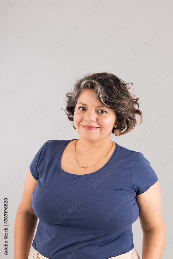 A woman with a blue shirt and a gold necklace is smiling A woman with a blue shirt and a gold necklace is smiling