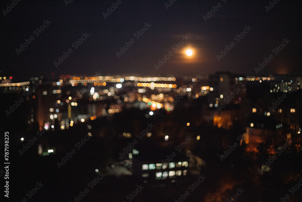Defocused photograph of Moon over night city Defocused photograph of Moon over night city