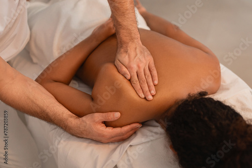 Male therapist giving a deep tissue massage