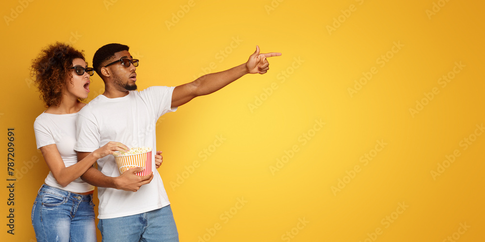 Shocked couple 3d glasses watching movie with popcorn Shocked couple 3d glasses watching movie with popcorn