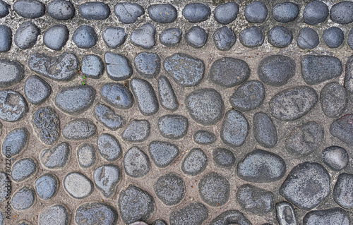 Concrete wall with river stones texture