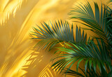 large palm leaves on a yellow background, in the style of youthful energy, sunrays shine upon it, sensory experience