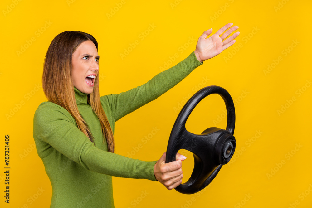 Profile photo of negative unsatisfied person hold wheel look empty space shout isolated on yellow color background Profile photo of negative unsatisfied person hold wheel look empty space shout isolated on yellow color background