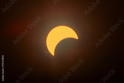 Partial Solar Eclipse with Sun's Crescent in Warm Skies © Nicholas J. Klein