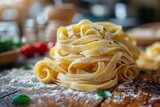 Close-up shot of twirled fresh homemade Italian fettuccine pasta sprinkled with flour on a rustic table